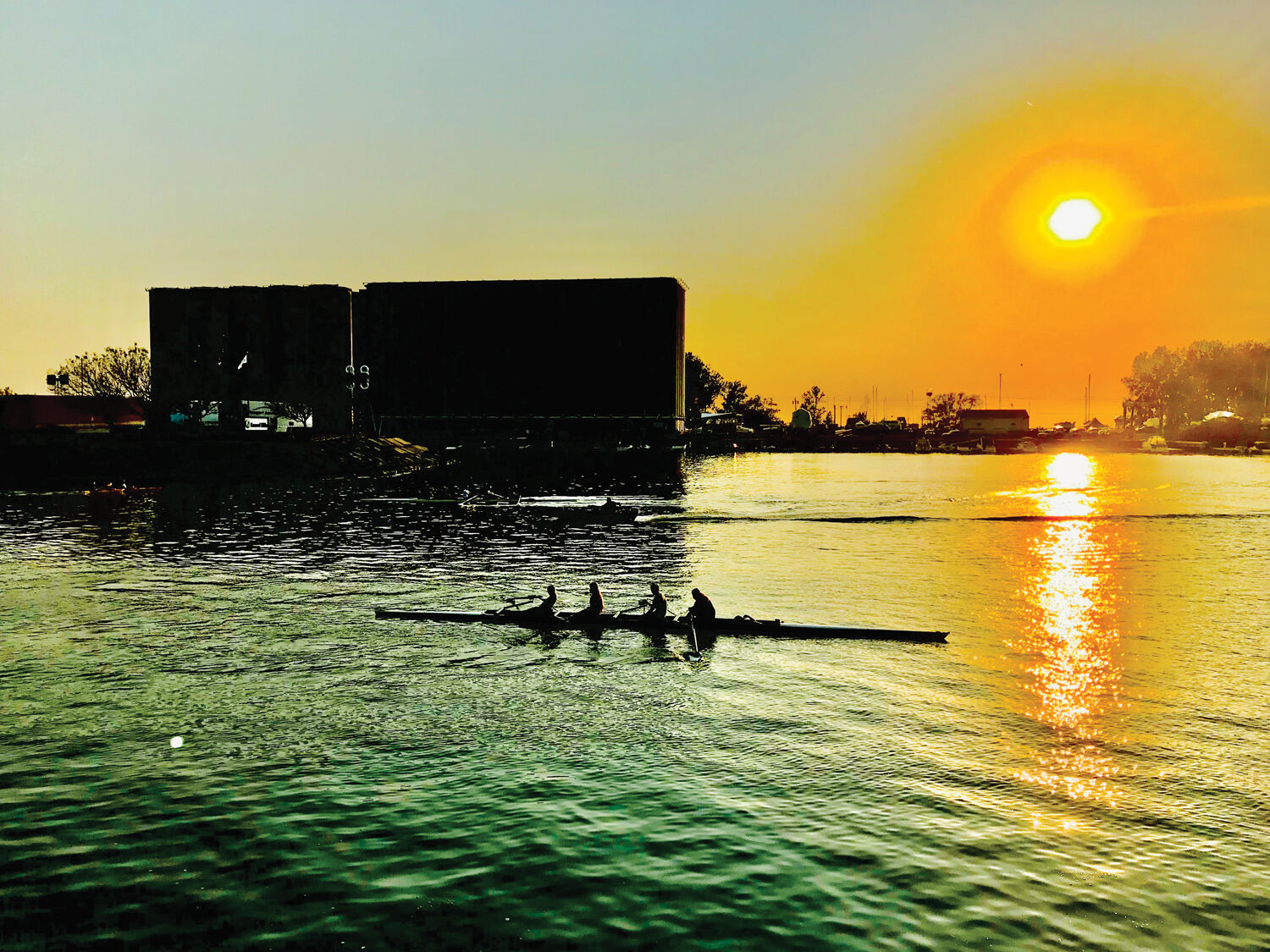 Four man crews on the canal at sunset